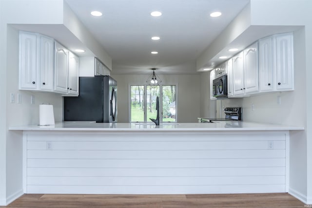 2375 N 110 W, Angola, IN 46703 - kitchen with appliances with stainless steel finishes, a peninsula, recessed lighting, a sink, and wood finished floors