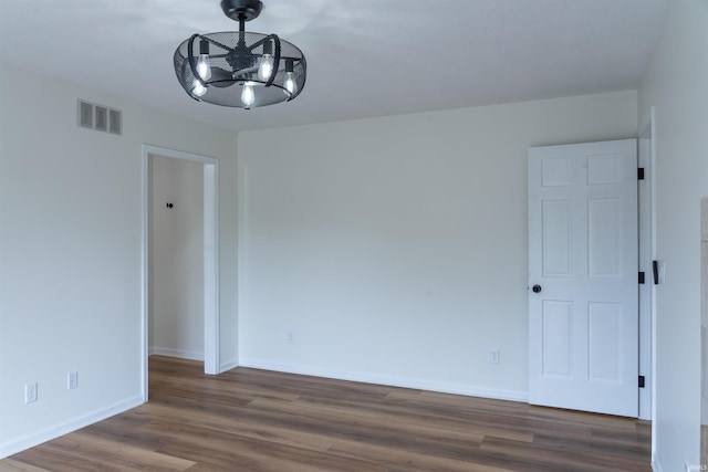 2375 N 110 W, Angola, IN 46703 - spare room with dark wood-type flooring, baseboards, and a chandelier