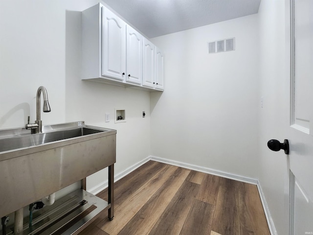 2375 N 110 W, Angola, IN 46703 - laundry room with cabinet space, hookup for a washing machine, dark wood finished floors, hookup for an electric dryer, and baseboards