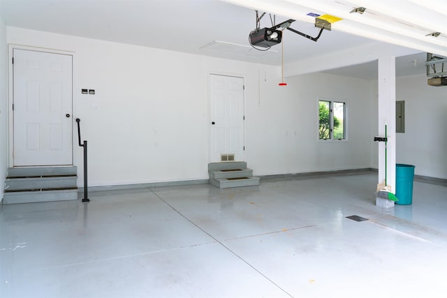 2375 N 110 W, Angola, IN 46703 - garage featuring a garage door opener, baseboards, and electric panel