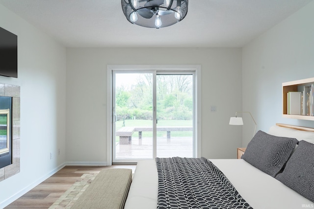 2375 N 110 W, Angola, IN 46703 - bedroom featuring access to exterior, wood finished floors, and baseboards