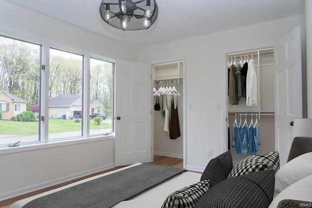 2375 N 110 W, Angola, IN 46703 - bedroom with two closets, a chandelier, wood finished floors, and baseboards