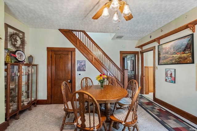 1919 Pierce St, Lafayette, IN 47904 - dining space with stairs, light carpet, a textured ceiling, baseboards, and ceiling fan