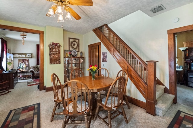 1919 Pierce St, Lafayette, IN 47904 - carpeted dining space with stairway, a ceiling fan, baseboards, and a textured ceiling