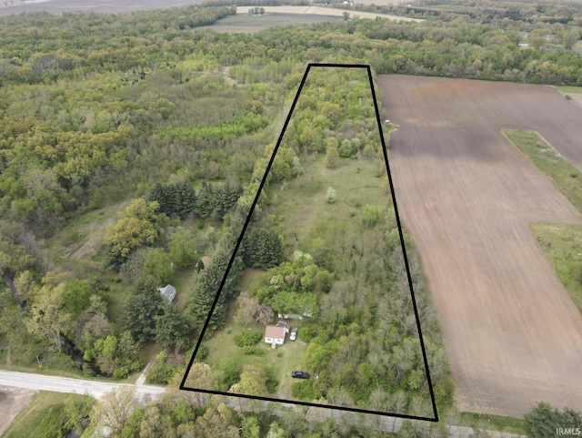 aerial view of property's location featuring property boundaries highlighted and a forest