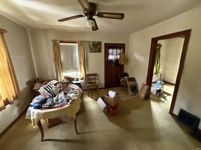 living area featuring ceiling fan and baseboards
