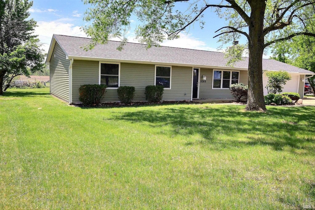 5203 W Dupont Rd, Fort Wayne, IN 46818 - ranch-style home with a front yard, roof with shingles, and an attached garage