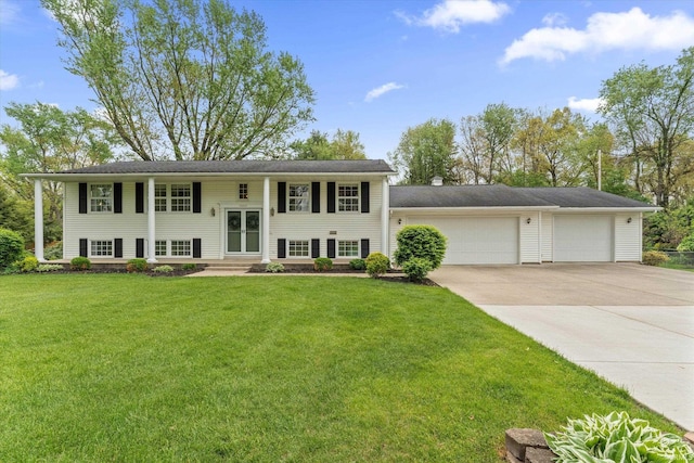 bi-level home featuring driveway, a front yard, and a garage