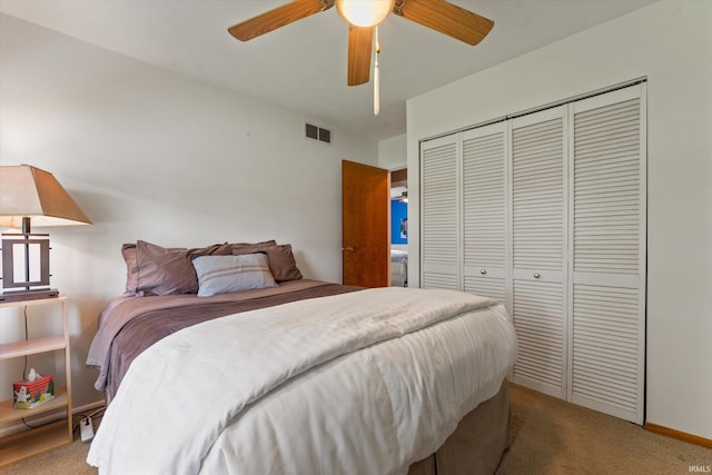 carpeted bedroom featuring a closet and ceiling fan