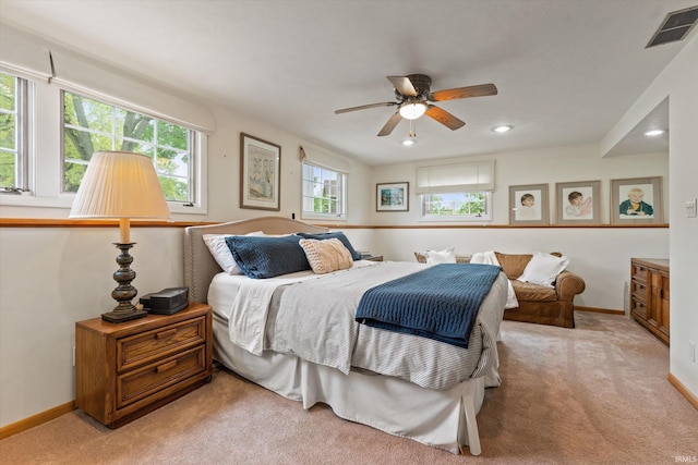 bedroom featuring light carpet, baseboards, and recessed lighting