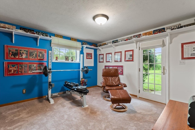 sitting room with carpet floors, a textured ceiling, and baseboards