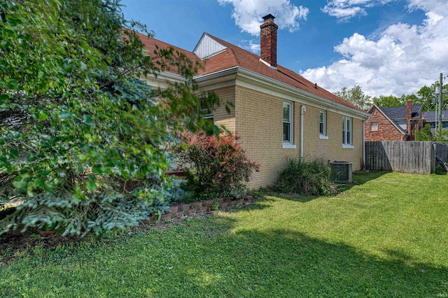 1908 E Mulberry St, Evansville, IN 47714 - view of side of home featuring brick siding, a chimney, and central AC unit