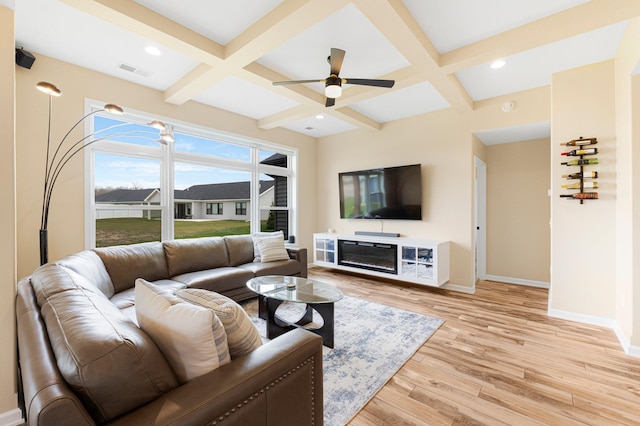 living room with coffered ceiling, baseboards, light wood-style flooring, beam ceiling, and a ceiling fan