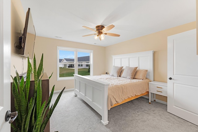 bedroom with light carpet, baseboards, and ceiling fan