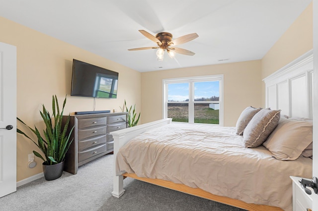 bedroom featuring light carpet, ceiling fan, and baseboards