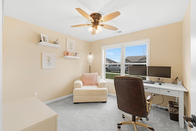 home office featuring carpet flooring, baseboards, and a ceiling fan