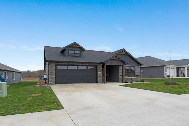 craftsman-style home featuring stone siding, driveway, a front yard, and board and batten siding