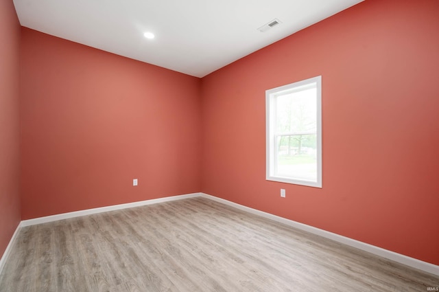 615 W Kickapoo St, Hartford City, IN 47348 - empty room featuring light wood-style floors, baseboards, and recessed lighting