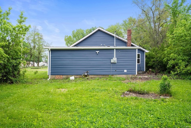 615 W Kickapoo St, Hartford City, IN 47348 - view of side of home with a chimney and a lawn