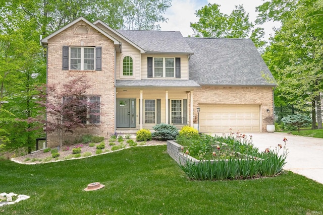 3630 E Tamarron Dr, Bloomington, IN 47408 - traditional-style home featuring brick siding, a front lawn, driveway, a garage, and roof with shingles