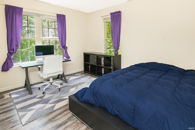 3630 E Tamarron Dr, Bloomington, IN 47408 - bedroom with wood finished floors, baseboards, and a desk
