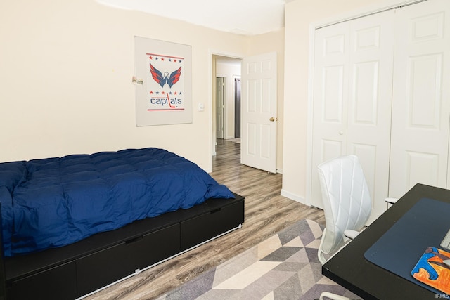 3630 E Tamarron Dr, Bloomington, IN 47408 - bedroom featuring wood finished floors, a closet, and baseboards