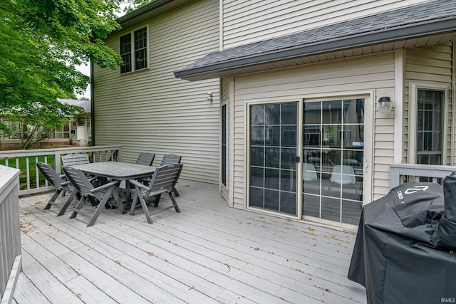 3630 E Tamarron Dr, Bloomington, IN 47408 - wooden deck with outdoor dining area and a grill