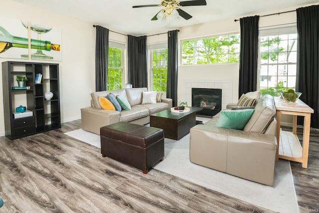 3630 E Tamarron Dr, Bloomington, IN 47408 - living area featuring wood finished floors, a ceiling fan, healthy amount of natural light, and a tile fireplace