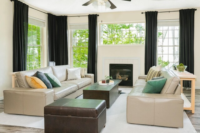 3630 E Tamarron Dr, Bloomington, IN 47408 - living room with ceiling fan, a tile fireplace, and wood finished floors