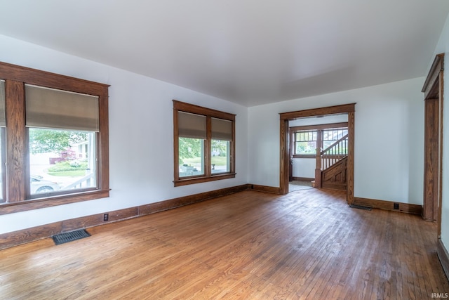 unfurnished room with wood finished floors and baseboards