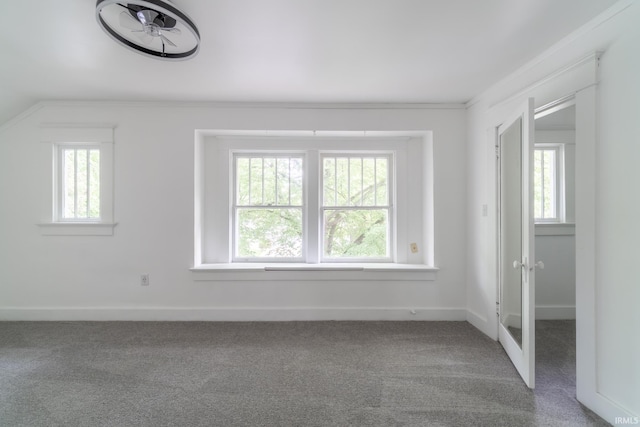 spare room featuring carpet floors, crown molding, baseboards, and french doors