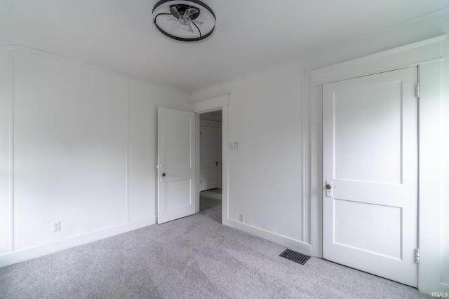 unfurnished bedroom with carpet flooring and baseboards