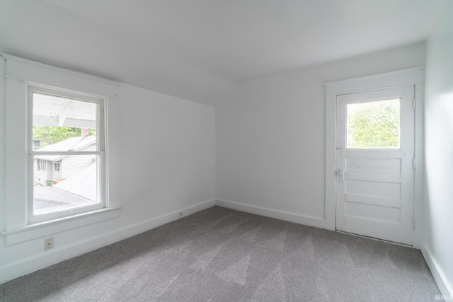 bonus room with carpet floors, plenty of natural light, lofted ceiling, and baseboards