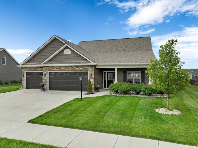 craftsman house with a front lawn, an attached garage, and driveway