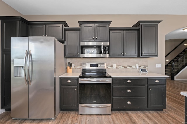 kitchen with stainless steel appliances, light wood-style flooring, and light countertops