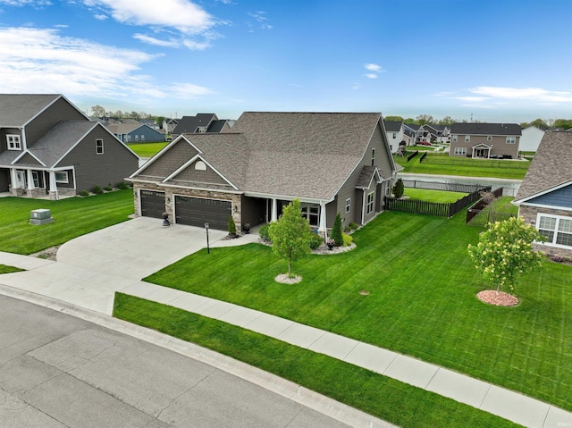 view of front of property with a residential view, an attached garage, concrete driveway, stone siding, and roof with shingles