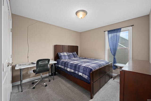 bedroom with carpet, baseboards, and a desk
