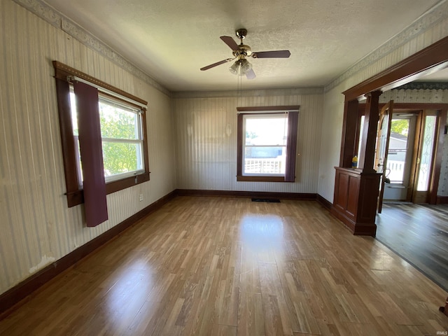 1107 S St, Bedford, IN 47421 - empty room with wallpapered walls, wood finished floors, a textured ceiling, baseboards, and ceiling fan