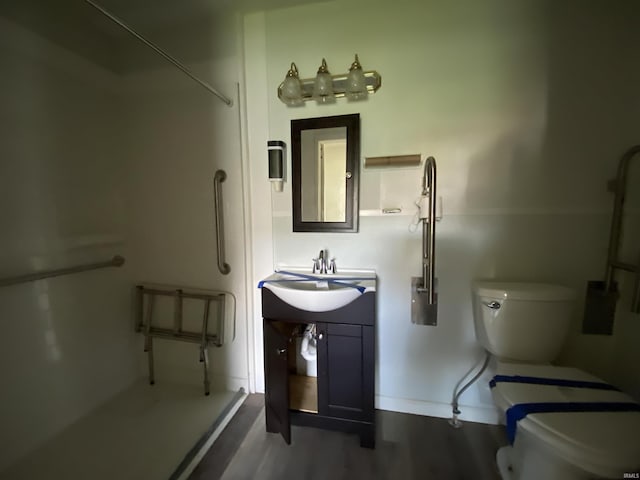 1107 S St, Bedford, IN 47421 - full bathroom featuring wood finished floors, a shower, toilet, and baseboards