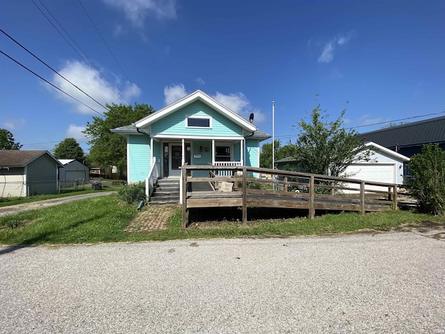 1107 S St, Bedford, IN 47421 - view of front of house with covered porch, a garage, and fence