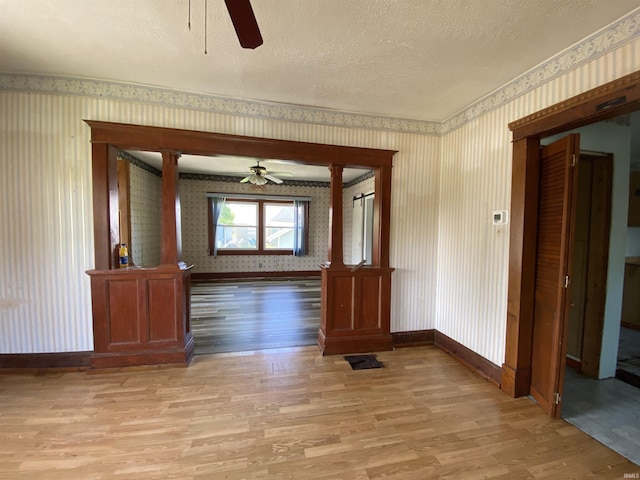1107 S St, Bedford, IN 47421 - unfurnished room with ceiling fan, wallpapered walls, light wood-type flooring, baseboards, and a textured ceiling