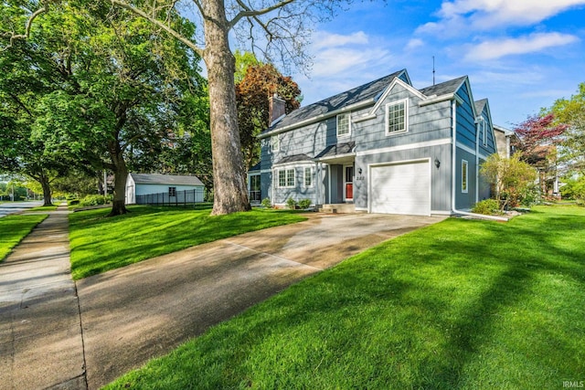 227 N Twyckenham Dr, South Bend, IN 46617 - traditional-style home with a garage, a chimney, and concrete driveway