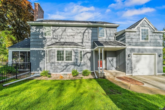 227 N Twyckenham Dr, South Bend, IN 46617 - traditional home featuring roof with shingles, concrete driveway, a chimney, and a garage