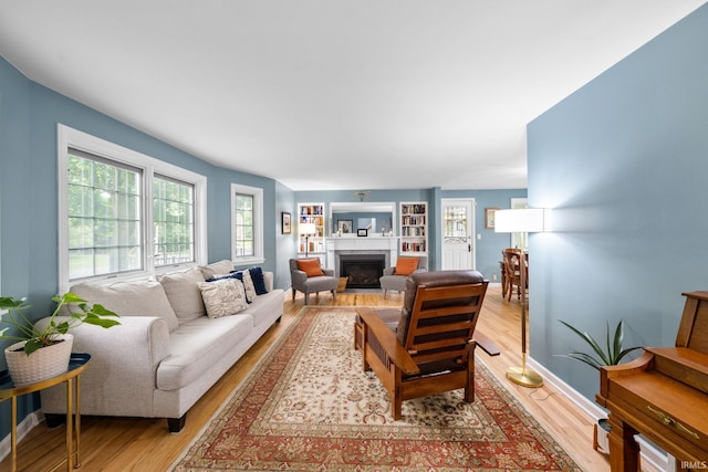 227 N Twyckenham Dr, South Bend, IN 46617 - living room featuring light wood-style floors, a fireplace, and baseboards