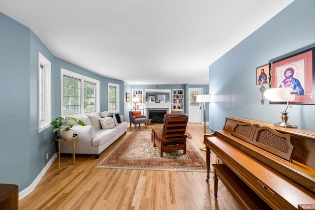 227 N Twyckenham Dr, South Bend, IN 46617 - living area with light wood-style floors, a fireplace, and baseboards