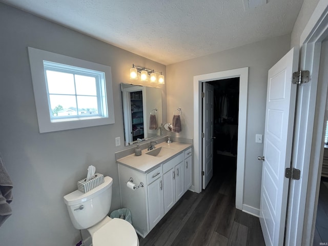 2327 Jamaica Ct, Evansville, IN 47725 - bathroom featuring wood finished floors, toilet, a textured ceiling, and vanity