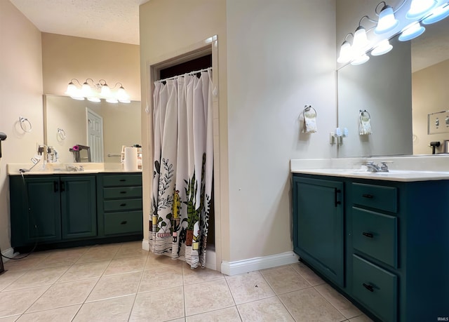 bathroom featuring tile patterned floors, vanity, and baseboards