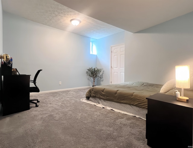carpeted bedroom with a textured ceiling and baseboards