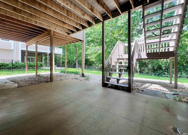 view of patio featuring stairway and fence