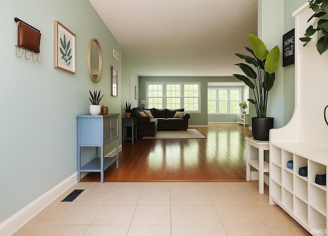 hall featuring baseboards and light wood-style flooring
